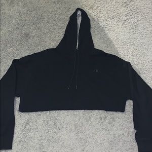 A black crop top “Champion” hoodie.